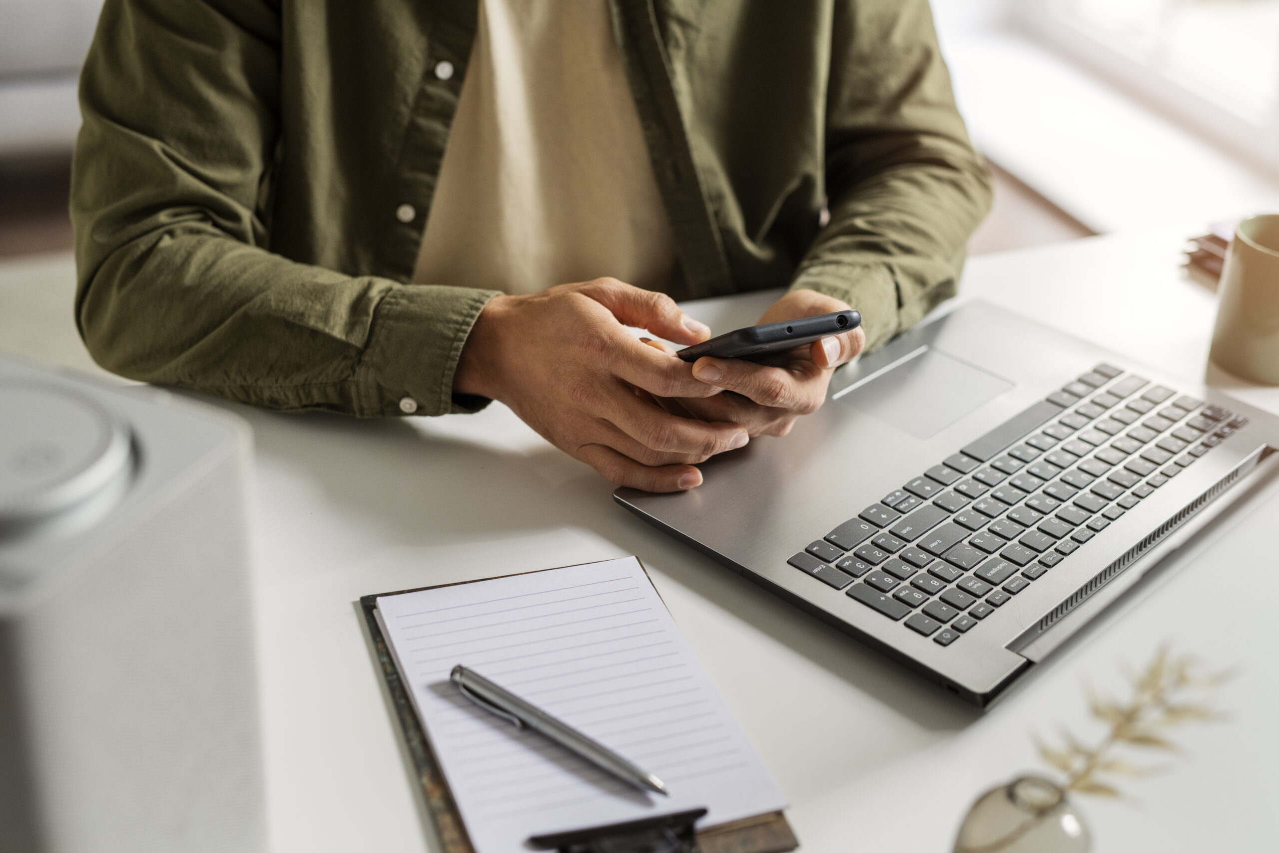 high angle man holding smartphone